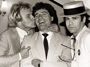 Images Dated 25th August 1982: Comedian Freddie Starr kisses England striker Kevin Keegan as Pop star Elton John looks