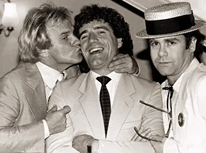 Footballer Prints: Comedian Freddie Starr kisses England striker Kevin Keegan as Pop star Elton John looks