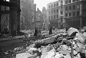 Commuters and City workers pick their way through a rubble strewn Stonecutters Street