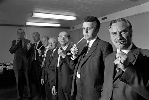 Competitiors in the British National Pipe Smoking Championship puffing on their pipes