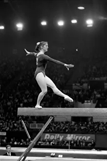 A competitor on the beam in the Champions All'Gymnastics Competition