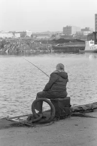 Solitude Prints: A competitor in the Daily MIrror Angling Competition at Surrey Docks, London