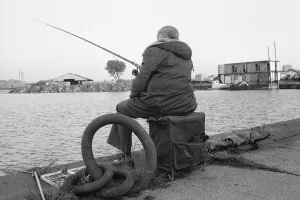 Solitude Prints: A competitor in the Daily MIrror Angling Competition at Surrey Docks, London