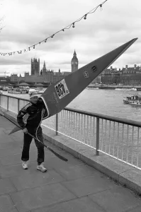 Big Ben Prints: Competitor in the Thames canoe race walks with his boat along the South Bank before