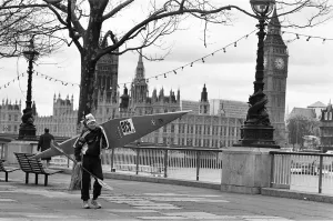 00969 Prints: Competitor in the Thames canoe race walks with his boat along the South Bank before