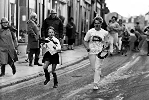 Competitors take part in the Alnwick Shrove Tuesday Pancake race 16 February 1988