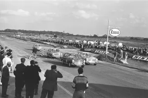 Competitors take the checkered flag in the Molyslip Morris 1100 race at Snetterton race
