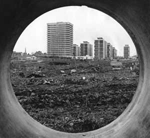 Redevelopment Prints: The concrete circle of a sewer pipe outlines the rapidly changing scene