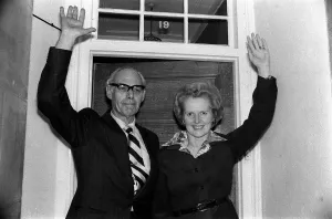00197 Prints: Conservative politician Margaret Thatcher waves at the front door of her home with