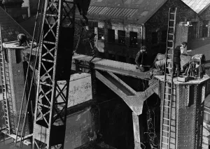 Construction of the new Tyne Bridge. A large crowd were keenly interested in the lifting