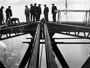 Bridge Prints: Construction of the new Tyne Bridge. Steel erectors standing where the top booms are
