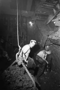 Construction workers digging the new Blackwall Tunnel in muddy and humid conditions
