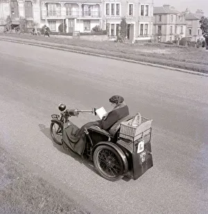 Wheelchair Prints: A converted motorbike turned into a three wheeled cab with whicker basket attachment