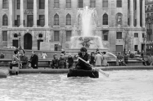 00967 Prints: Coracle fishermen in London. One of the fishermen paddles his coracle round Trafalgar