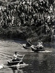 00362 Prints: Coracle Racing - Tense moment during a coracle race as crowds line the banks of the River