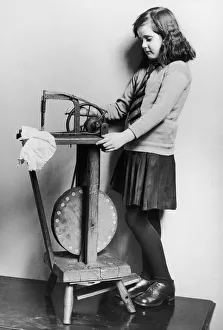 00355 Prints: Corinne Griffith seen here in the role of Mary Boyne sitting working at a Singer sewing