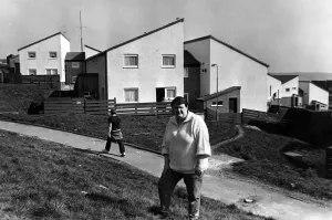 Council tenant liaison officer Denise Yeates outside refurbished houses on the Penrhys