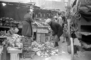 Council workers clear away the waste fruit and veg from around Kingston markets green