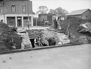 Council workmen constructing a public air raid shelter outside Lloyds Bank in Church Road