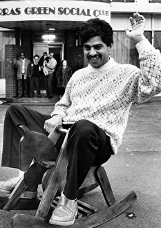 Councillor Raj Malhotra, sits on a rocking house as he helps fundraising appeal on behalf