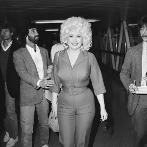 Country & Western singer Dolly Parton arrving at London Airport. 22nd March 1983