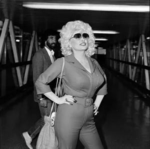 Country & Western singer Dolly Parton arrving at London Airport. 22nd March 1983