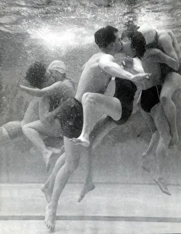 Excercise Prints: Couples searching for privacy beneath the waters of the pool steal a shy kiss