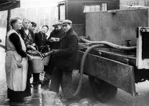 00104 Prints: Coventry Corporation workers taking water round to residents that have been bombed