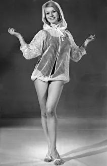 00030 Prints: This cover-up with drawstring hood is in white peep-through fishnet