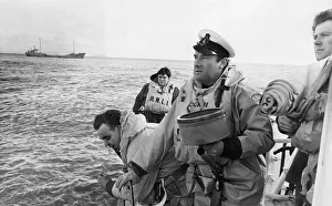 Crew Prints: Coxswain of the Barry Lifeboat Mr. Frank Tinsley watches the life line land on the rocks