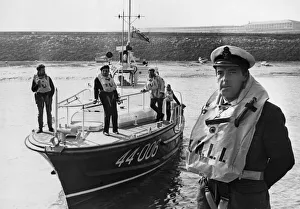 Coxswain Frank Tinsley stands in from of the Barry lifeboat RNLB Arthur