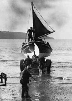 Coxswain Tom Patton and engineer Bob Taylor assisting in the launch of a lifeboat