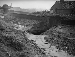 The crater left after a direct hit on the Birmingham to Worcester canal at the Bournville