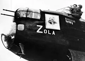 Crew of an RAF Avro Lancaster bomber point to nose art on their plane WW2 1942