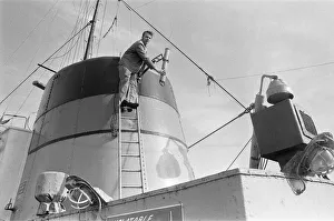 Fisherman Prints: Crewman on the St Gerontius seen here repairing the ships radio antenna. 11th March 1978
