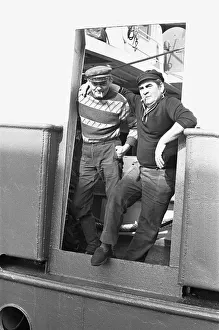 Trawler Prints: Crewman of the trawler Magritte seen here having a cigarette whilst tied up at St Andrews