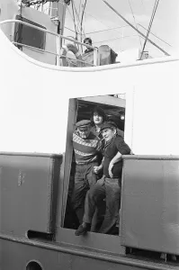 01026 Prints: Crewman of the trawler Magritte seen here having a cigarette whilst tied up at St Andrews