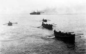 Crews of sunken German ships being rowed to a waiting English war vessel after coming