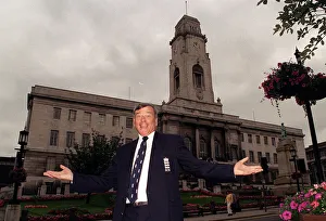 Towns Prints: Cricket umpire Dickie Bird poses in front of Barnsley Town Hall as he celebrates his