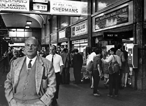 The crowded booking hall at Cardiff Central railway station as people make