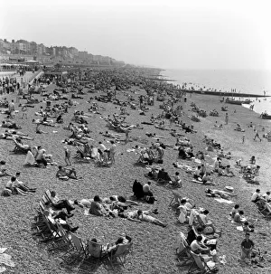 Brighton Prints: Crowded scenes on Brighton Beach as holidaymakers enjoy the hot summer weather