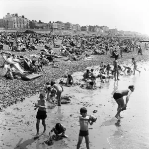 Crowded scenes on Brighton Beach as holidaymakers enjoy the hot summer weather