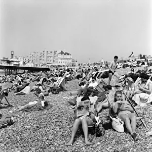 00591 Prints: Crowded scenes on Brighton Beach as holidaymakers enjoy the hot summer weather