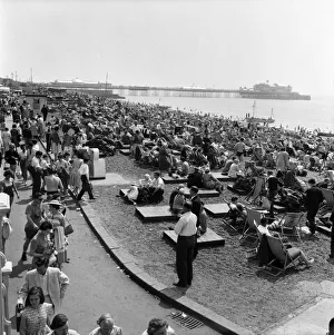 00591 Prints: Crowded scenes on Brighton Beach as holidaymakers enjoy the hot summer weather