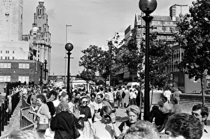 Crowds of people line the dock road set for a day out at Liverpool Albert Dock to see