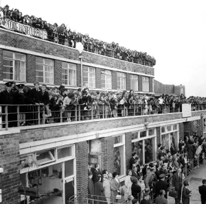 Rooftops Prints: Crowds wait patiently for the The Beatles to arrive at Liverpool Airport for