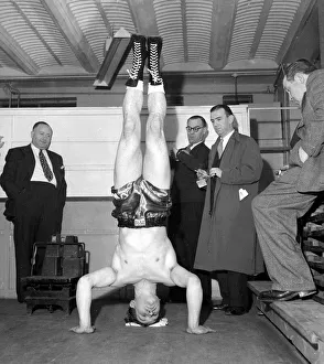 Acrobatic Prints: Cruiser weight boxer George walker doing a head stand at the weigh in November 1957
