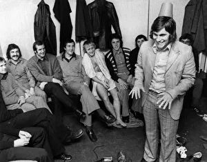 00493 Prints: Crystal Palace footballer Peter Taylor entertains the rest of the squad with his Tommy