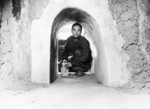 Tunnel Prints: At Cu Chi 50 miles from Saigon ex Vietcong Minh soldier shows part of the 200 mile