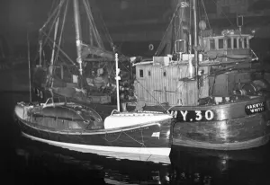 Tyne And Wear Prints: Cullercoats lifeboat safely tied up near the trawlers at the fish quay North Shields